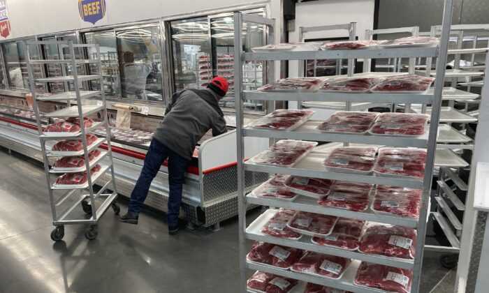 An employee restocks meats at a grocery store in North Miami on Jan. 17, 2023. (Wilfredo Lee/AP Photo)